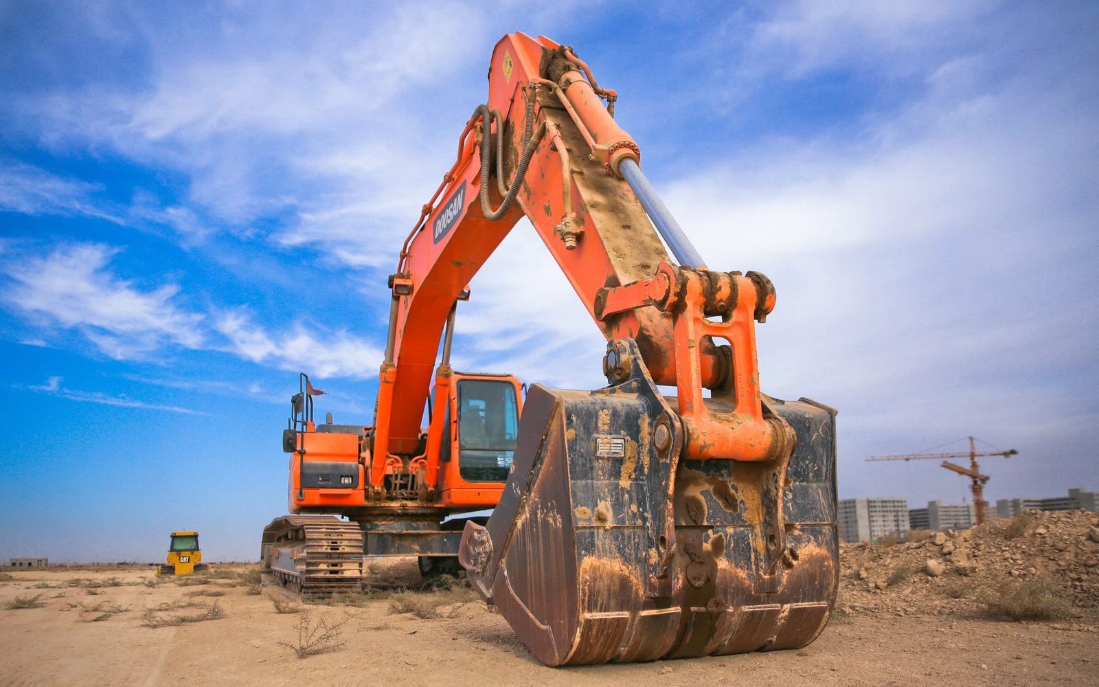 An excavator out on rental on a working site