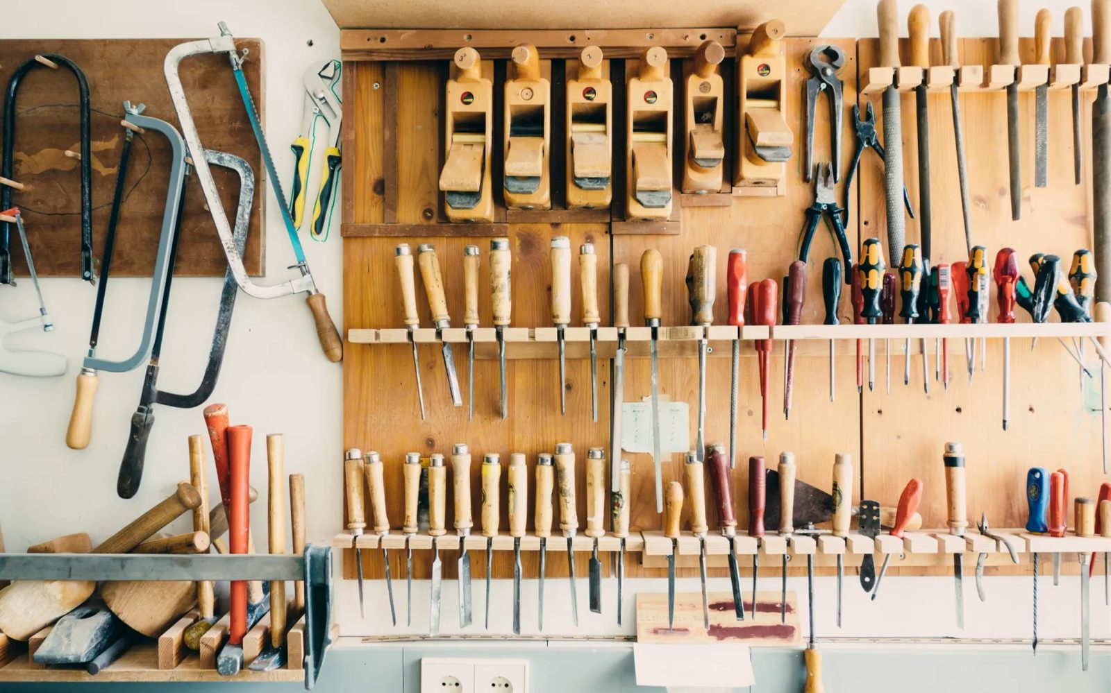 Hand tools racked on a workshop wall